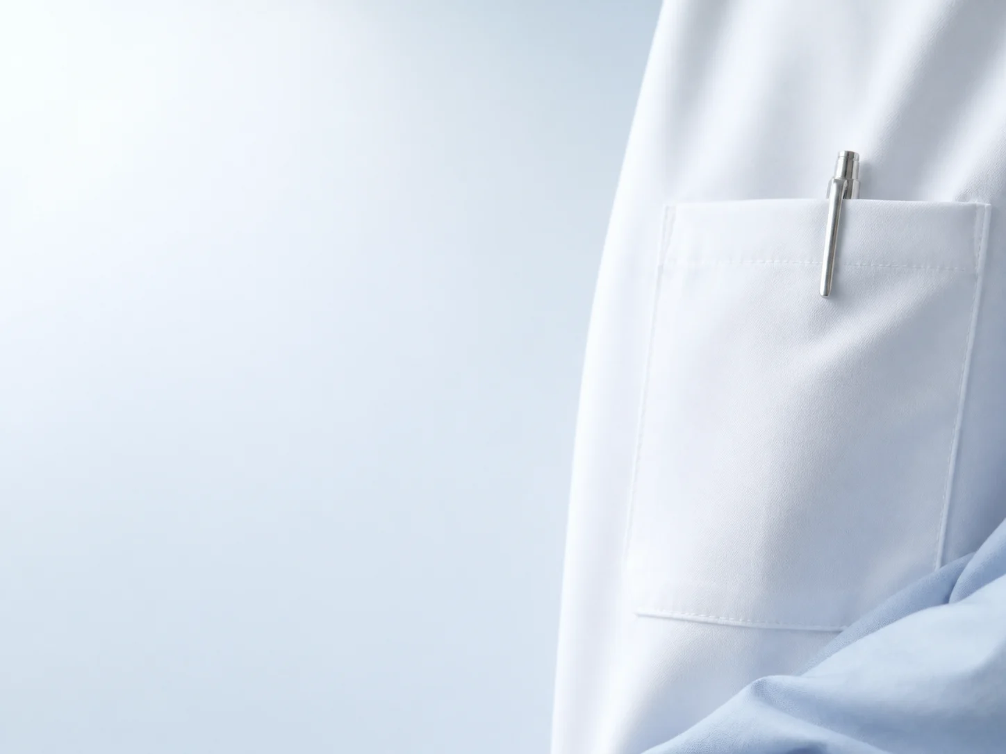 Clinical coat detail representing the people behind everyday care.