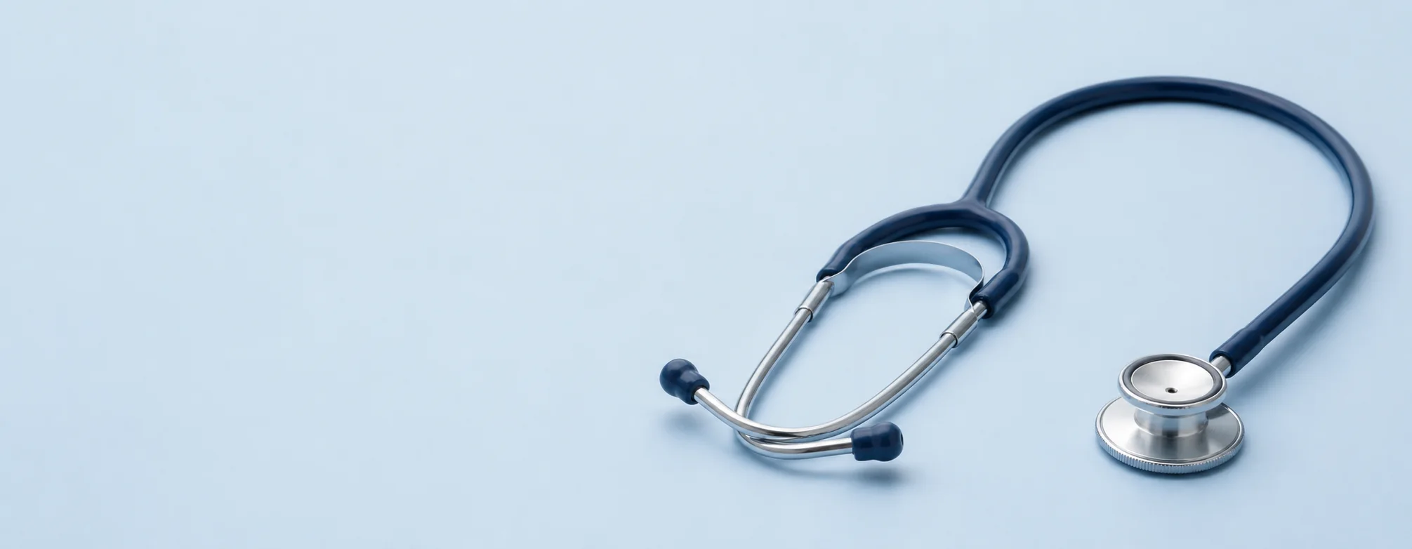 Close-up of a stethoscope on a pale blue surface